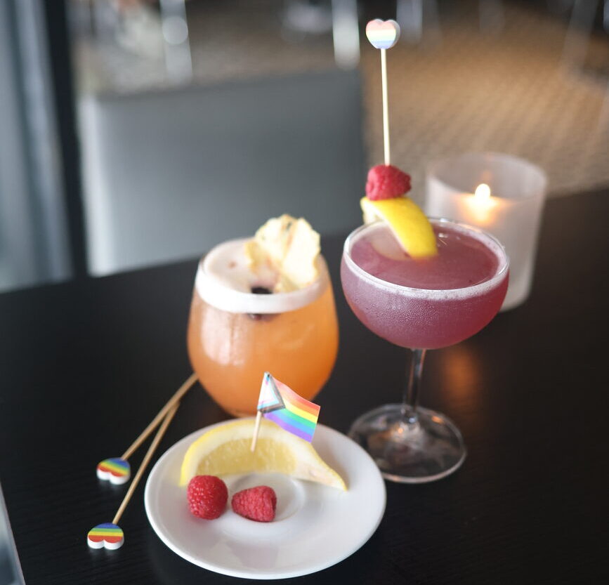 Two cocktails and a pride flag.